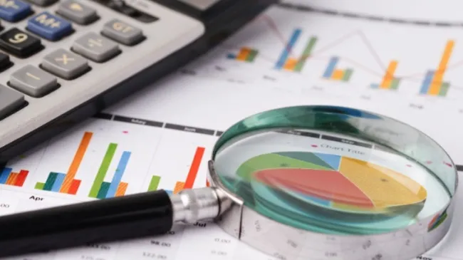 magnifying glass and graphs